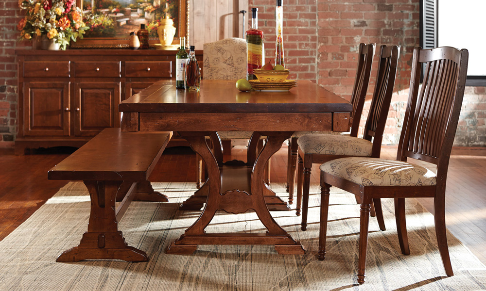 Rectangular wooden table with wooden and upholstered chairs.