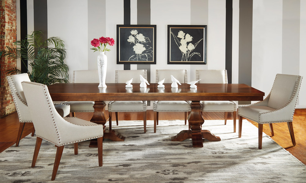 Extended rectangular table and cream colored upholstered chairs.