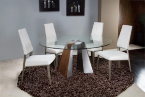 Round glass dining table and white chairs.
