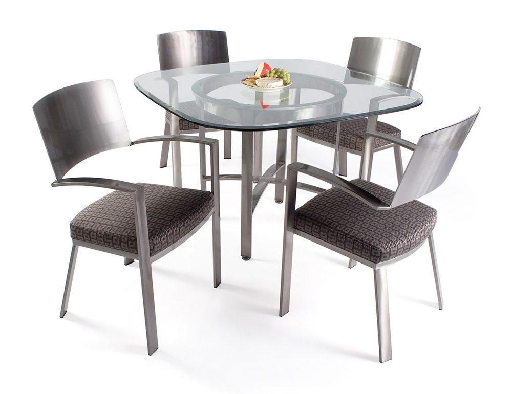 Round glass dining table and metal and upholstered design dining chairs.