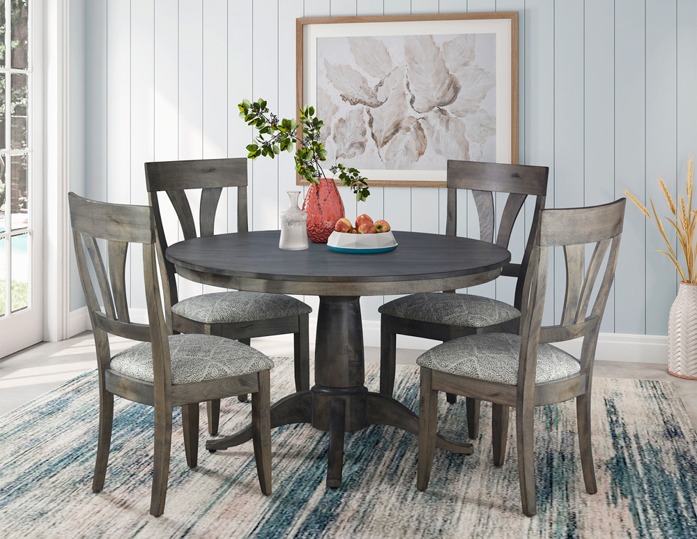 Round wooden dining table and upholstered wood chairs.