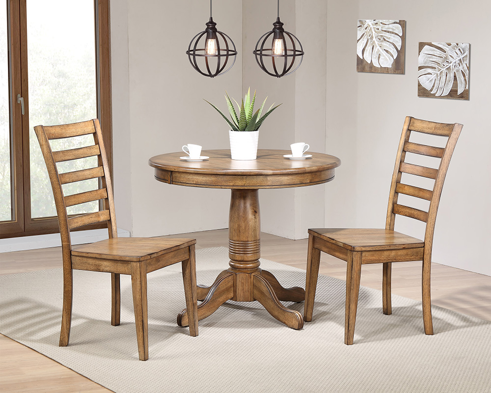 Round wood bistro-style table with pedestal and two ladder-back wood chairs. 