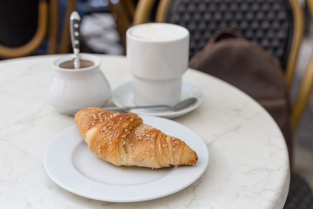 outdoor furniture at a bistro with a croissant