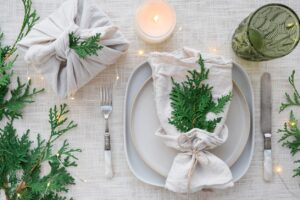 Close up of a holiday place setting with greenery. 
