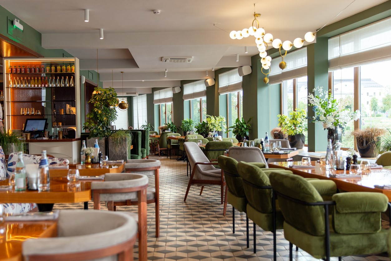 An empty contemporary restaurant with different styles of tables and seating.