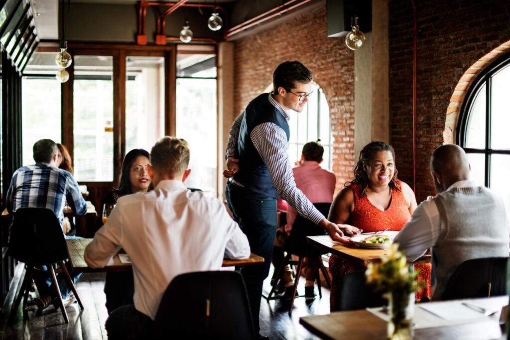 People eating dinner in a small restaurant in the Bay Area. 