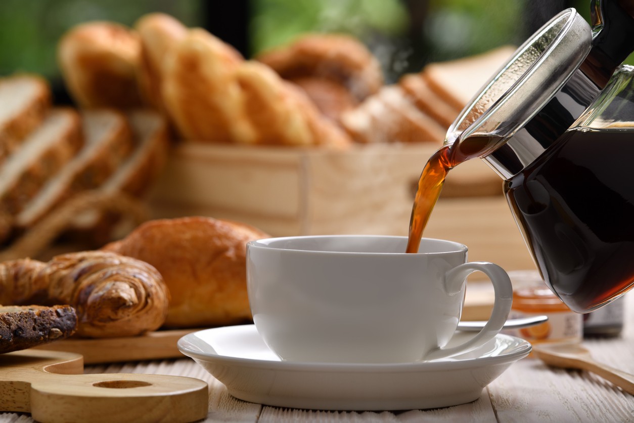 Close up of coffee and croissants on a cafe table.