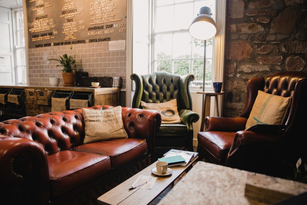 Living room style restaurant furniture with armchairs and leather sofas. 