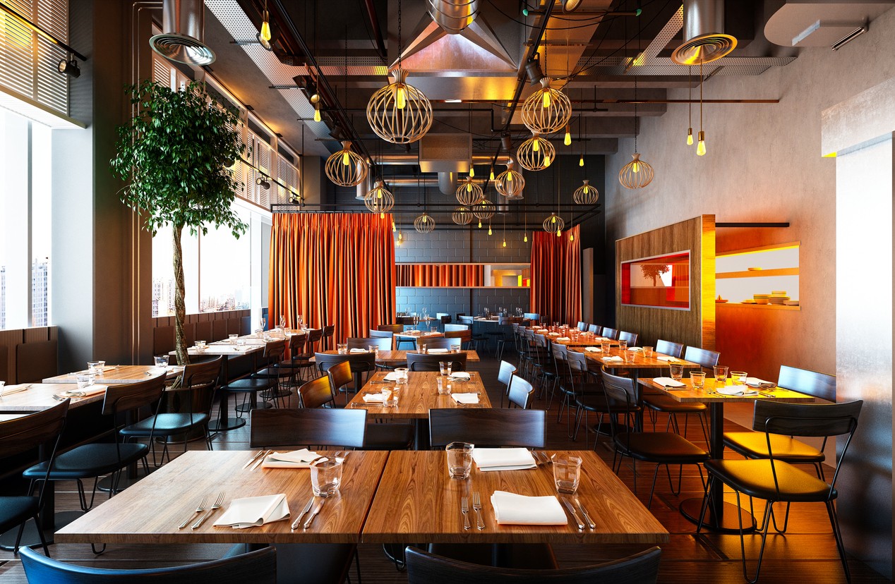 Restaurant with ambient lighting, wooden tables, and metal chairs.