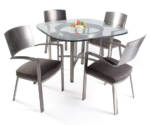 Round glass dining table and metal and upholstered design dining chairs.